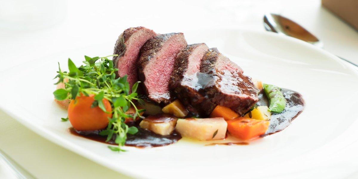 Sunday Lunch sliced beef with veg on a white plate - Bryn Berwyn Tresaith Cardigan Bay