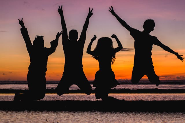 Silhouette of Family jumping on a beach - Fathers Day - Bryn Berwyn Tresaith