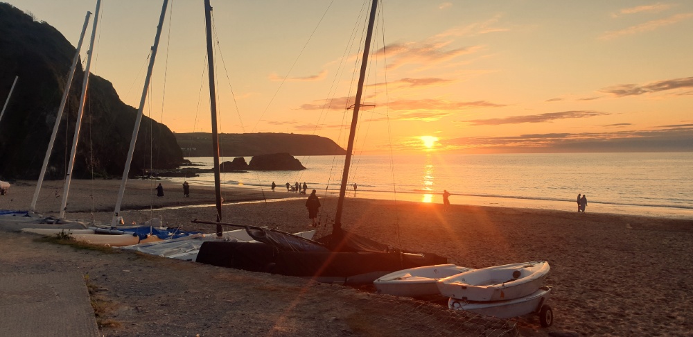 Sunset with sailboats on Tresaith beach