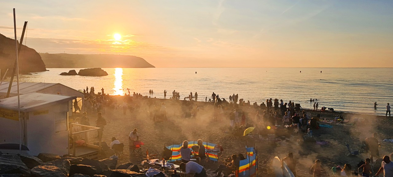 People on beach with fires - Tresaith Mariners beach party live music event 2025